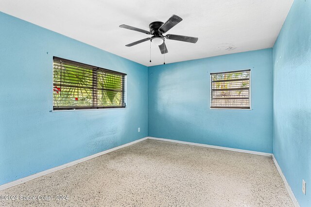 spare room with ceiling fan