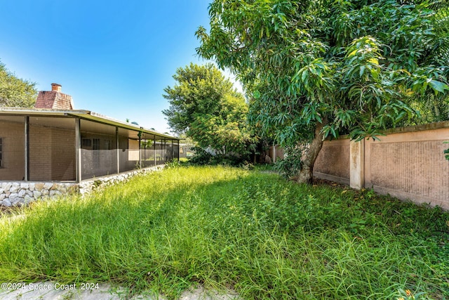 view of yard featuring a sunroom