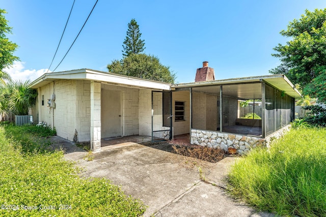 view of front of property with cooling unit and a sunroom