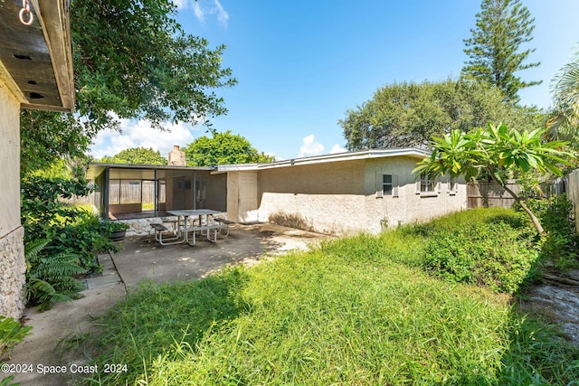 back of property with a patio