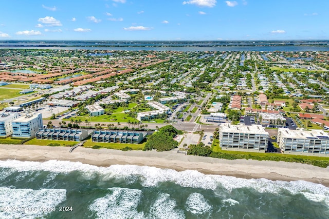 aerial view with a water view and a view of the beach