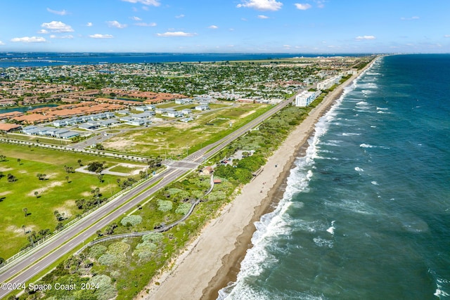 bird's eye view featuring a water view and a beach view