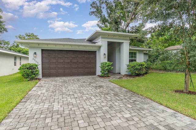 view of front of house with a garage and a front yard