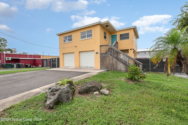 view of front of house with a garage and a front lawn