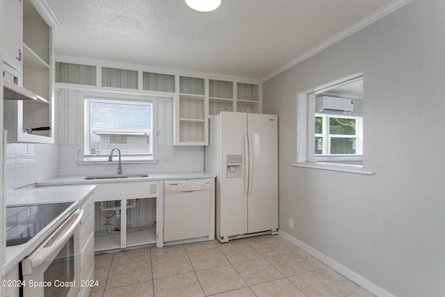 kitchen featuring a wealth of natural light, light tile patterned floors, white appliances, and tasteful backsplash