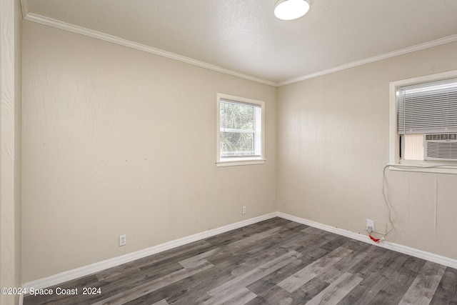 spare room featuring cooling unit, dark hardwood / wood-style flooring, crown molding, and a textured ceiling