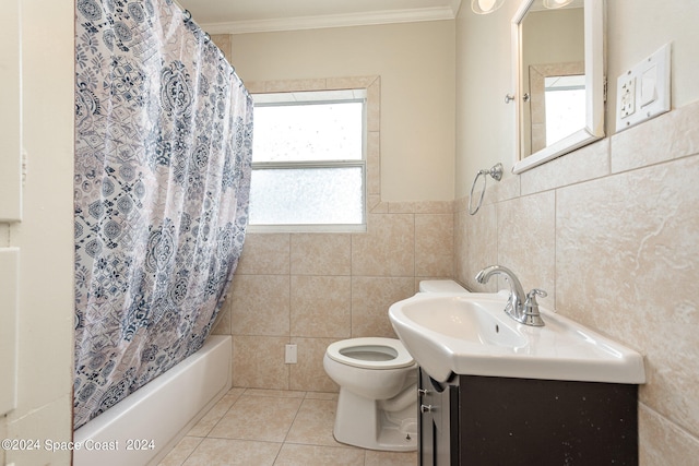 full bathroom featuring tile walls, toilet, plenty of natural light, and vanity