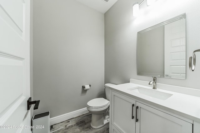 bathroom featuring hardwood / wood-style floors, vanity, and toilet