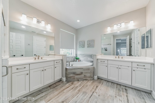 7356 Millbrook Ave, Melbourne, FL 32940 - full bathroom featuring a shower stall, a bath, two vanities, and a sink