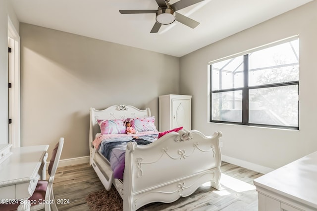 7356 Millbrook Ave, Melbourne, FL 32940 - bedroom with baseboards, light wood-style flooring, and ceiling fan