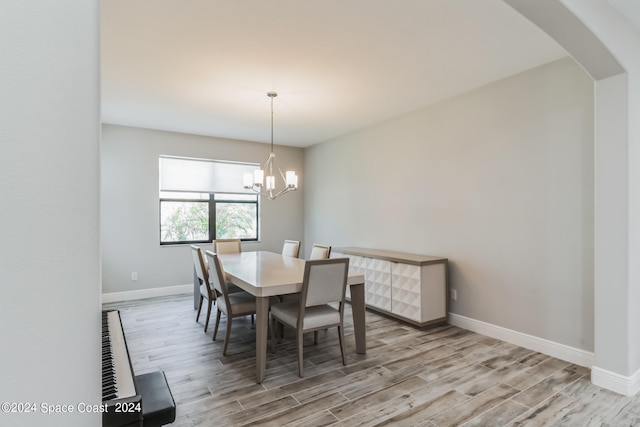 dining room featuring a notable chandelier and light hardwood / wood-style flooring