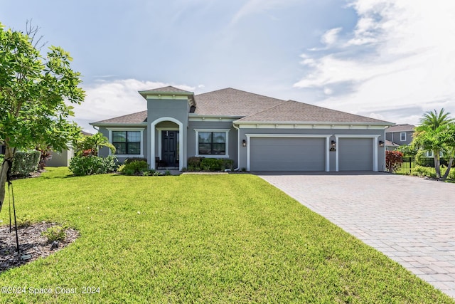 7356 Millbrook Ave, Melbourne, FL 32940 - mediterranean / spanish home featuring decorative driveway, a garage, stucco siding, a shingled roof, and a front yard
