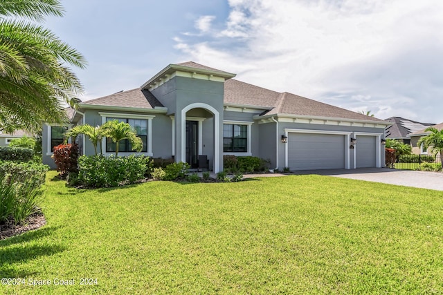 7356 Millbrook Ave, Melbourne, FL 32940 - mediterranean / spanish house featuring driveway, an attached garage, stucco siding, a shingled roof, and a front yard
