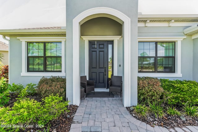 7356 Millbrook Ave, Melbourne, FL 32940 - view of exterior entry with covered porch and stucco siding