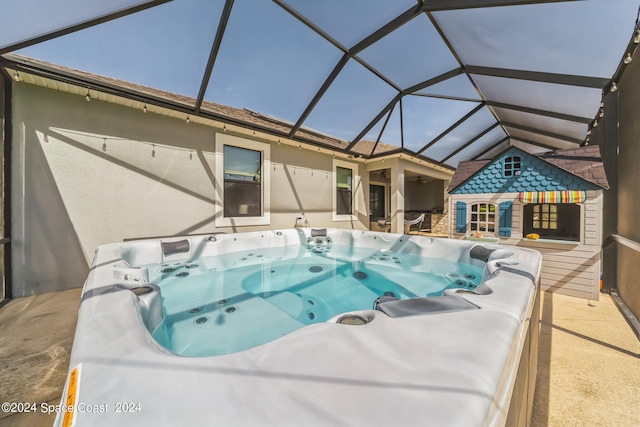 view of swimming pool with glass enclosure and a hot tub