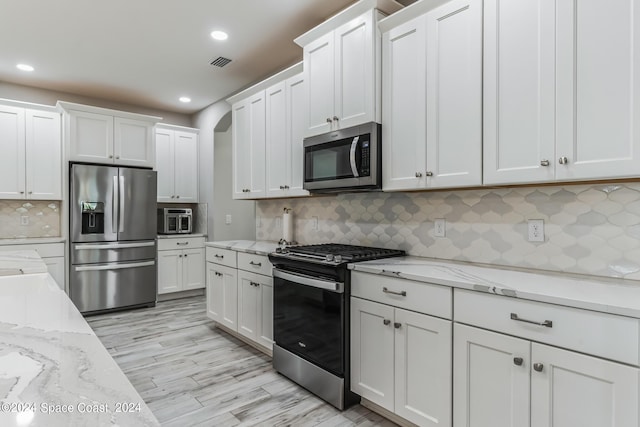7356 Millbrook Ave, Melbourne, FL 32940 - kitchen featuring stainless steel appliances, visible vents, recessed lighting, decorative backsplash, and white cabinets