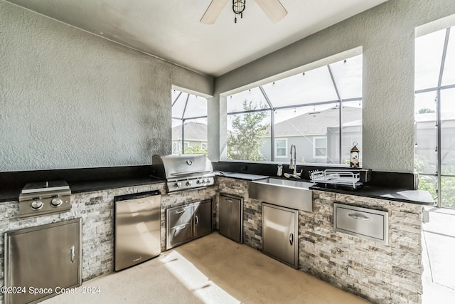 view of patio with a lanai, area for grilling, sink, and exterior kitchen