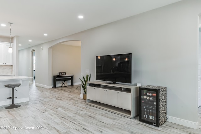 living room with light hardwood / wood-style flooring and beverage cooler