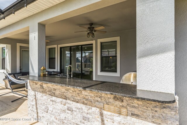 7356 Millbrook Ave, Melbourne, FL 32940 - view of patio featuring exterior kitchen, a ceiling fan, and outdoor wet bar
