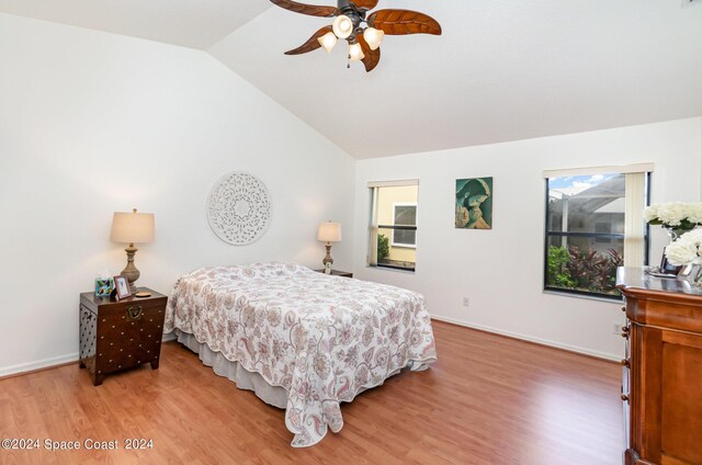 bedroom with lofted ceiling, hardwood / wood-style flooring, and ceiling fan