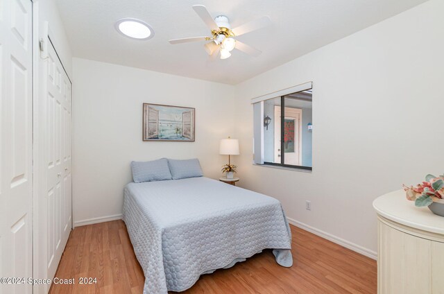 bedroom with hardwood / wood-style floors, a closet, and ceiling fan