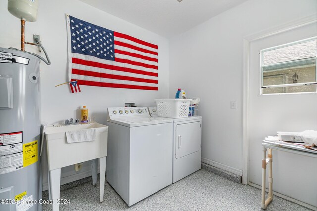 laundry room featuring independent washer and dryer and water heater