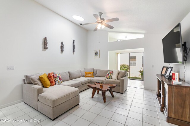 tiled living room featuring lofted ceiling and ceiling fan