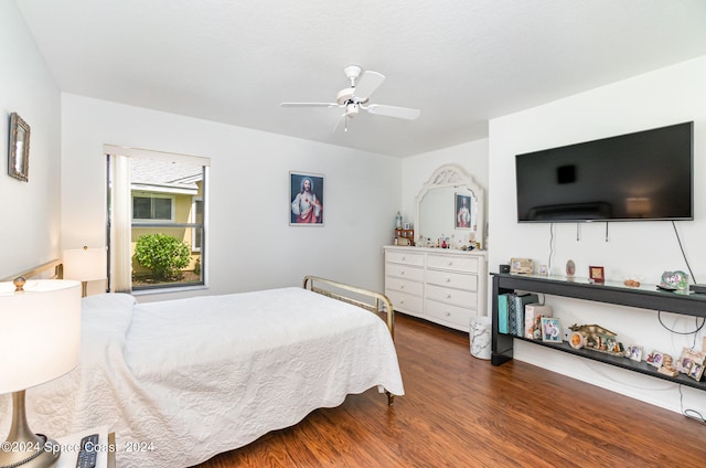 bedroom with dark wood-type flooring and ceiling fan