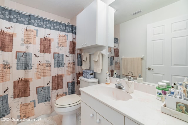 bathroom featuring vanity, toilet, tile patterned flooring, and a textured ceiling