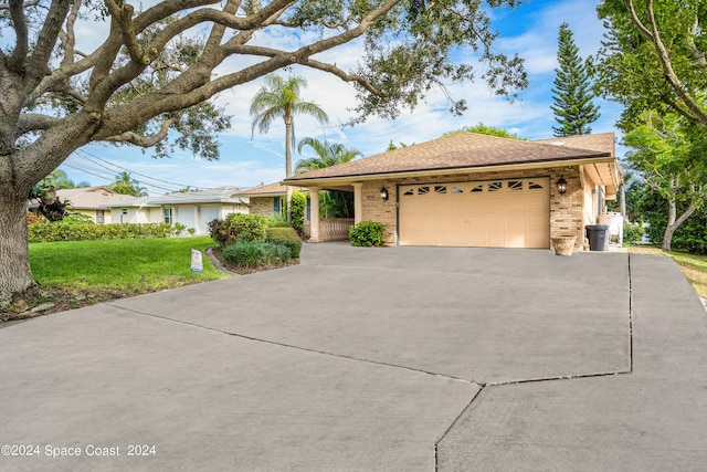 ranch-style house featuring a garage and a front yard