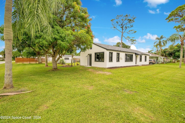 back of house featuring a lawn