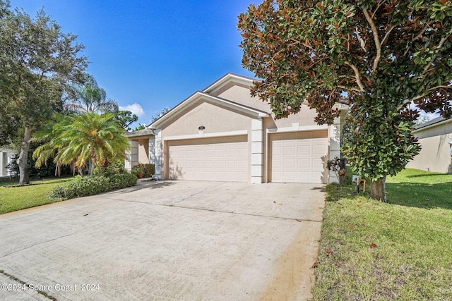 view of front of property with a front lawn and a garage