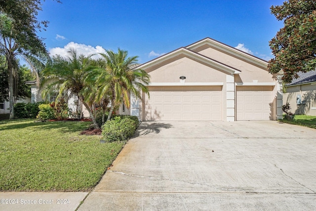 single story home with a garage and a front lawn