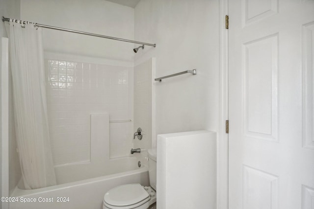 bathroom with shower / bath combo and toilet