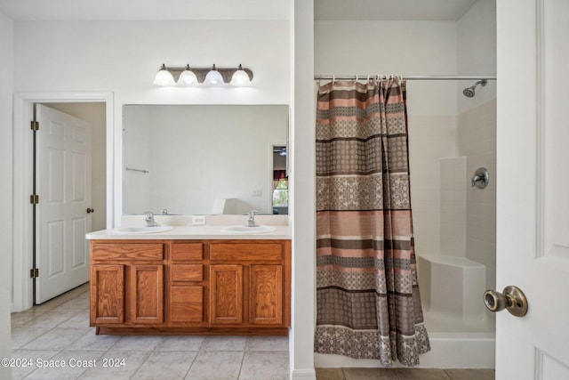 bathroom featuring tile patterned floors, vanity, and curtained shower