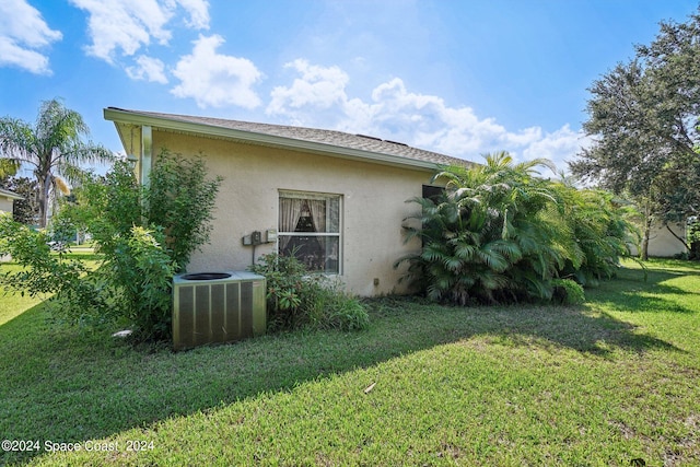 view of property exterior featuring cooling unit and a lawn