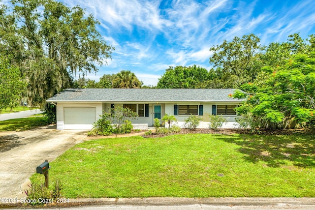 ranch-style home with a garage and a front yard