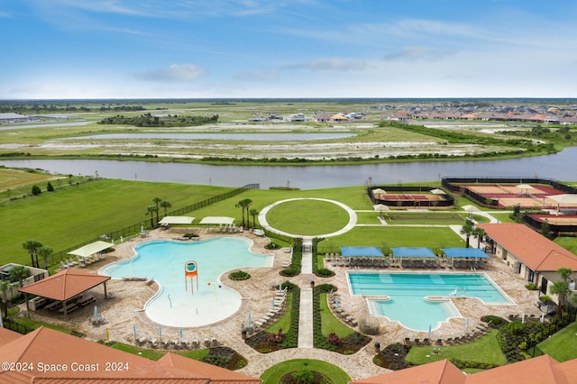 view of pool with a patio and a water view