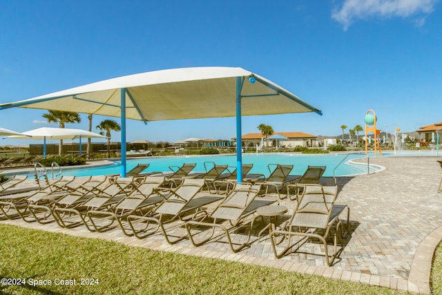 view of swimming pool featuring a patio and pool water feature