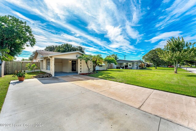 single story home with a front lawn and a carport