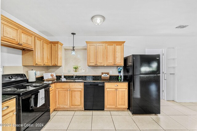 kitchen with dark stone countertops, backsplash, decorative light fixtures, black appliances, and sink