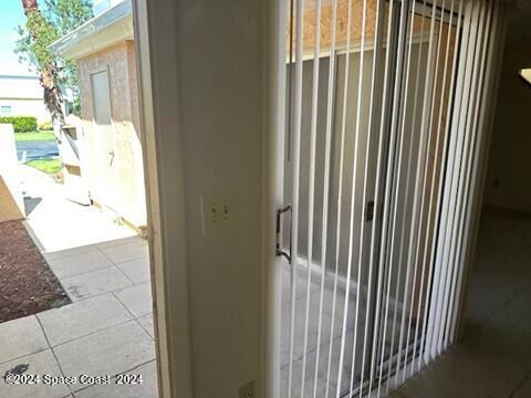 exterior details featuring tile patterned flooring