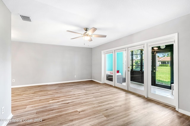 spare room featuring ceiling fan and light hardwood / wood-style floors