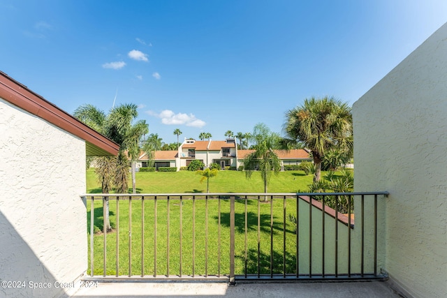 view of yard with a balcony