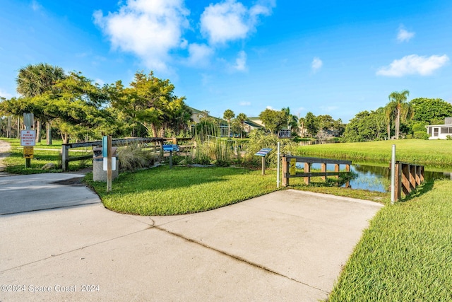 view of property's community featuring a water view and a lawn