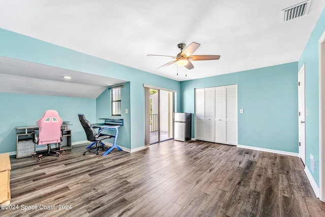 home office with ceiling fan, vaulted ceiling, and hardwood / wood-style flooring