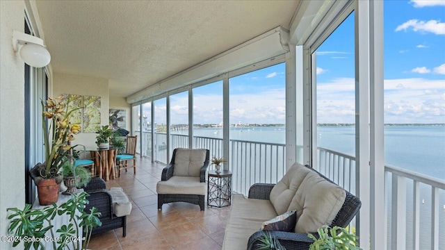 sunroom / solarium featuring a water view