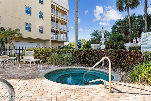 view of swimming pool with a community hot tub