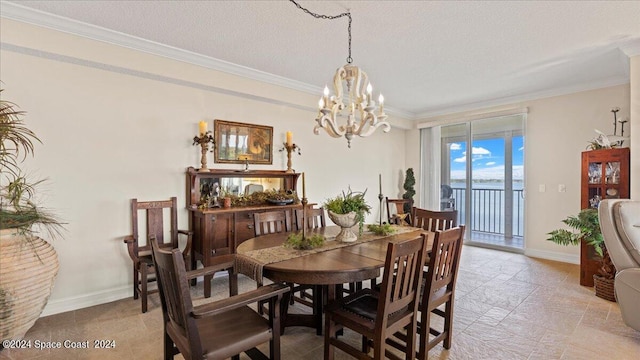 dining area featuring ornamental molding, a notable chandelier, and a textured ceiling