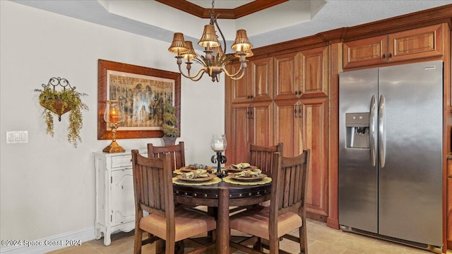 dining room with a chandelier, crown molding, and a raised ceiling